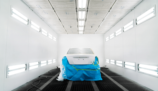 car in a spray paint booth